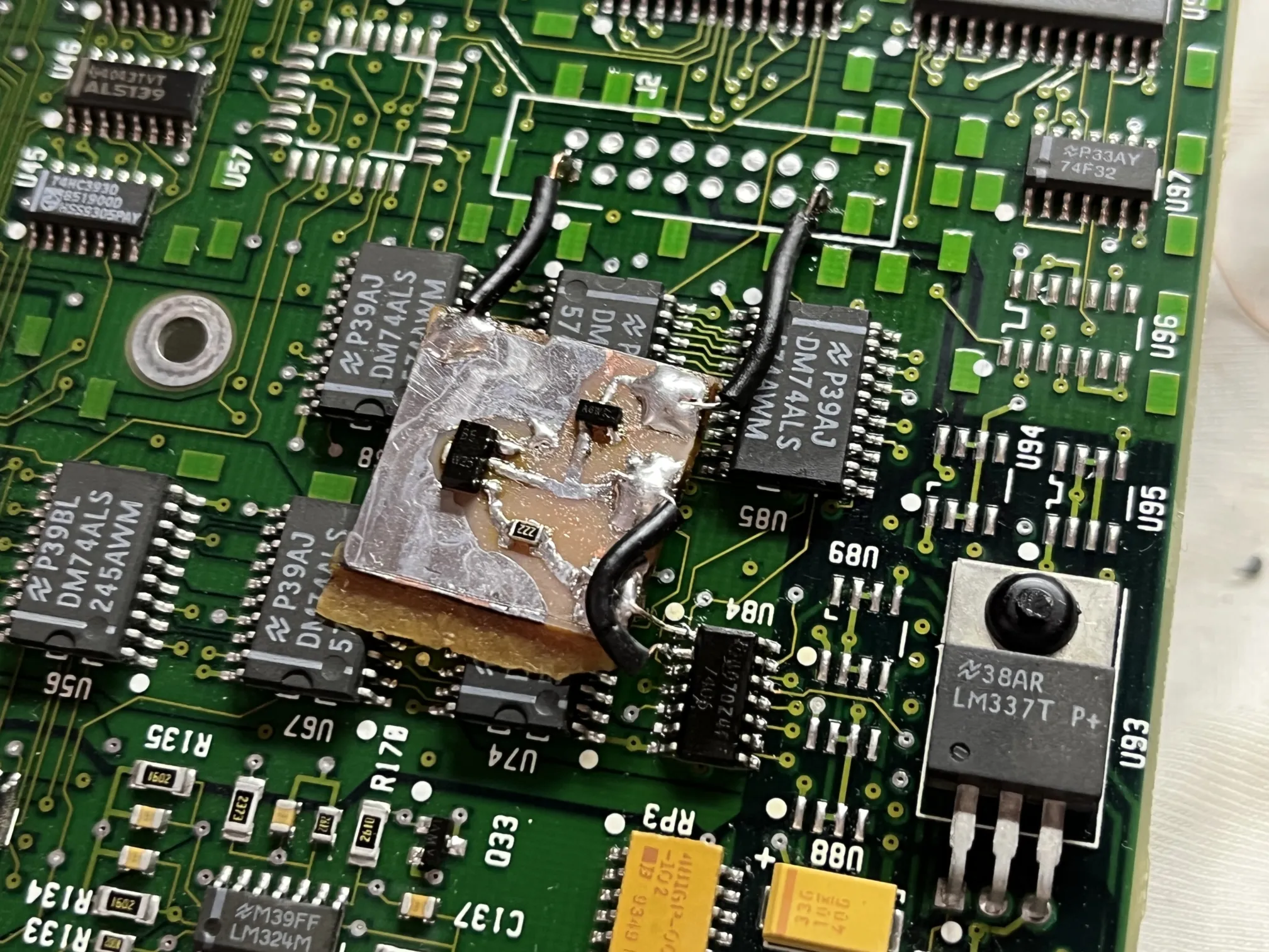 inverting buffer circuit board attached with thin wires to various points on a pcb